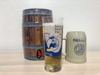A picture of a small barrel, a pitcher and a glas with beer