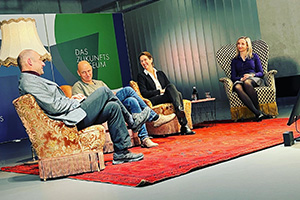 Four persons (fltr. Stefan Rieger, Prof. Halik, Prof. Büttner, Prof. Castiglione) sitting on recycled armchairs in a semicircle