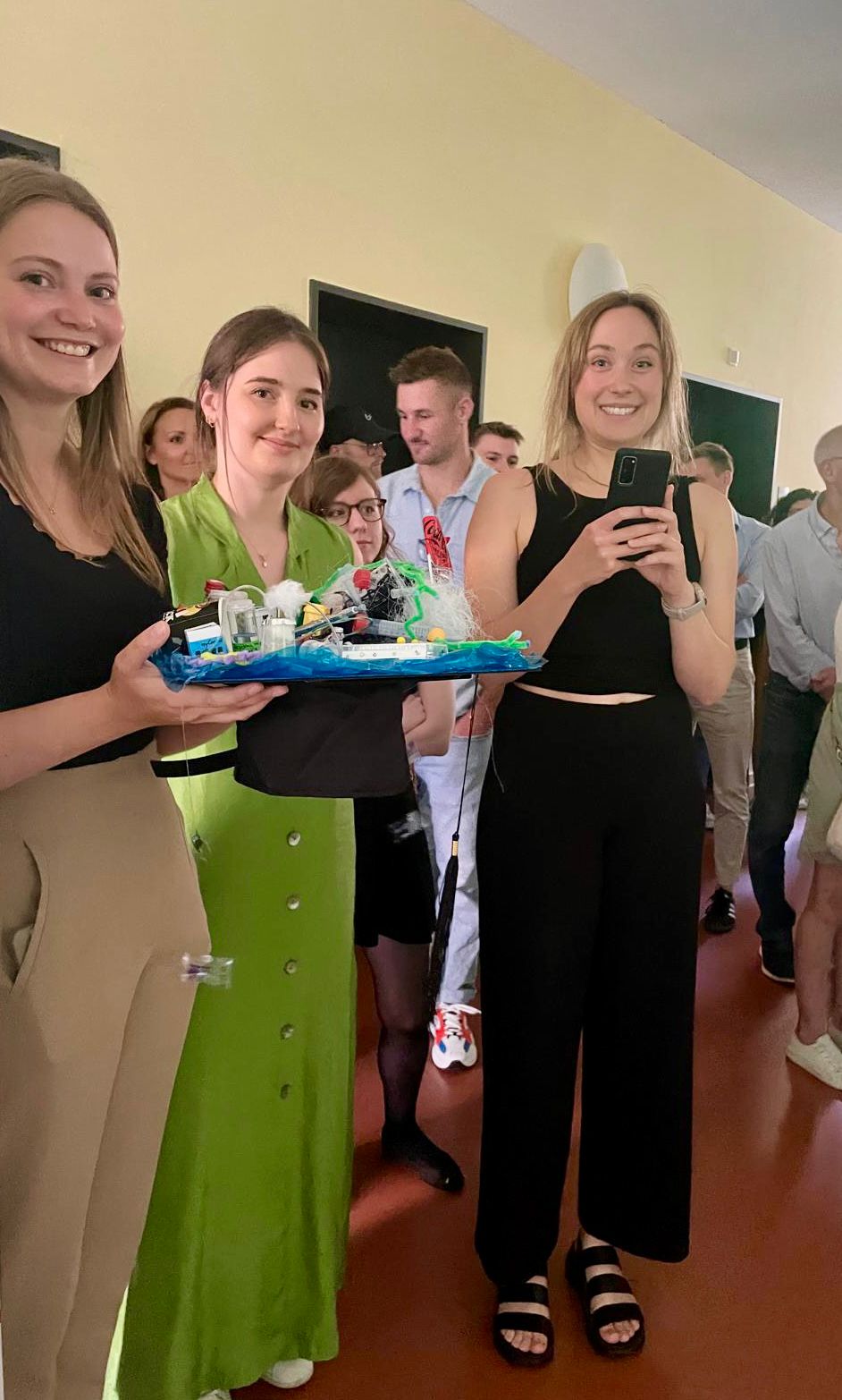 Three female PhD students with a doctor hut